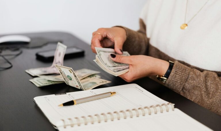 Woman counting cash - flow budgeting