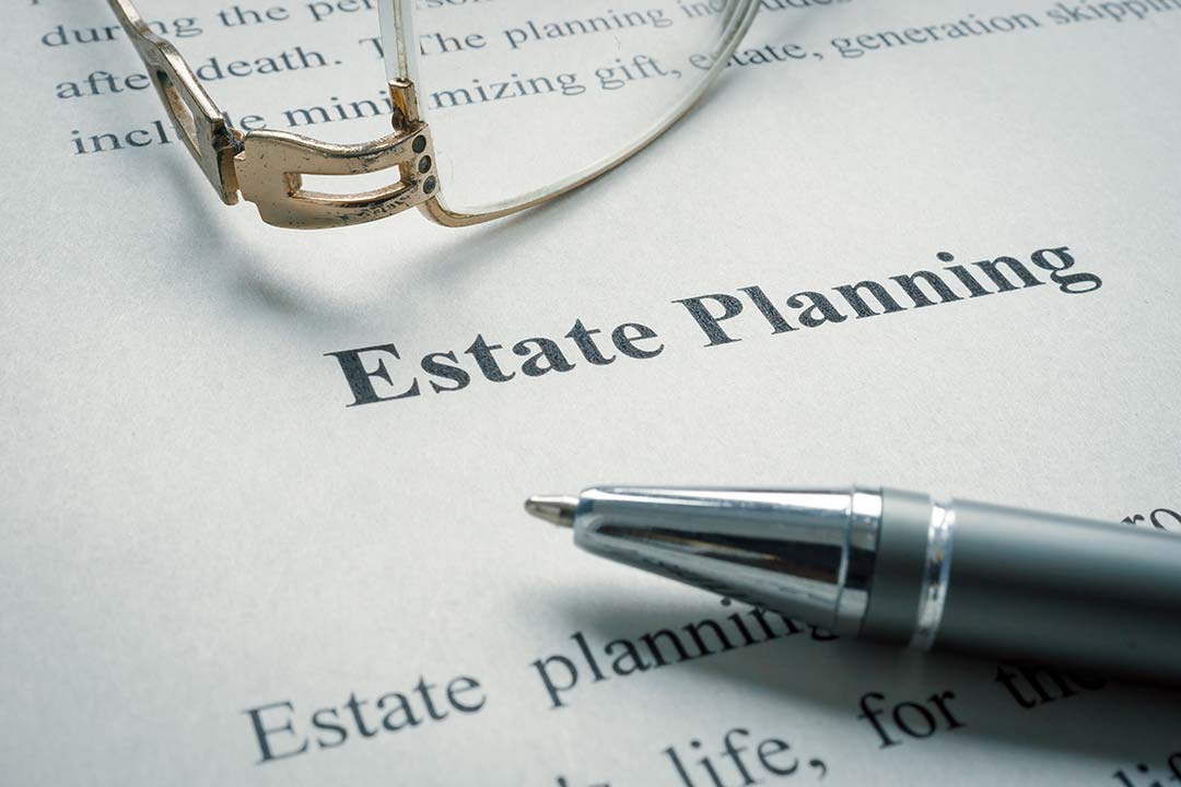 Glasses and pen on estate planning document