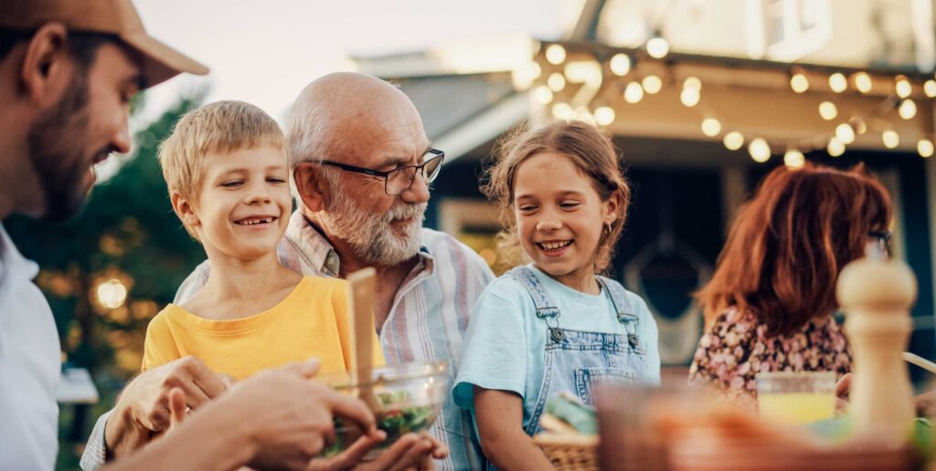 Family gathering outdoors with food.