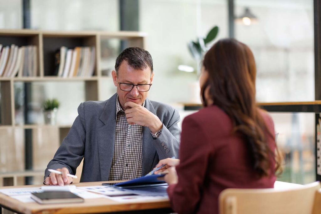 Man talking with woman financial advisor
