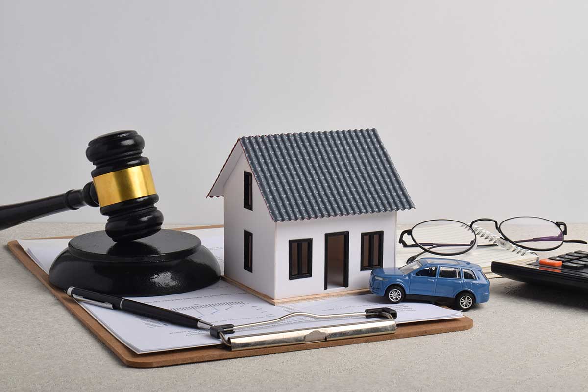Gavel, house model, car, paperwork.