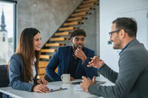 Three professionals engaged in discussion about financial advising.