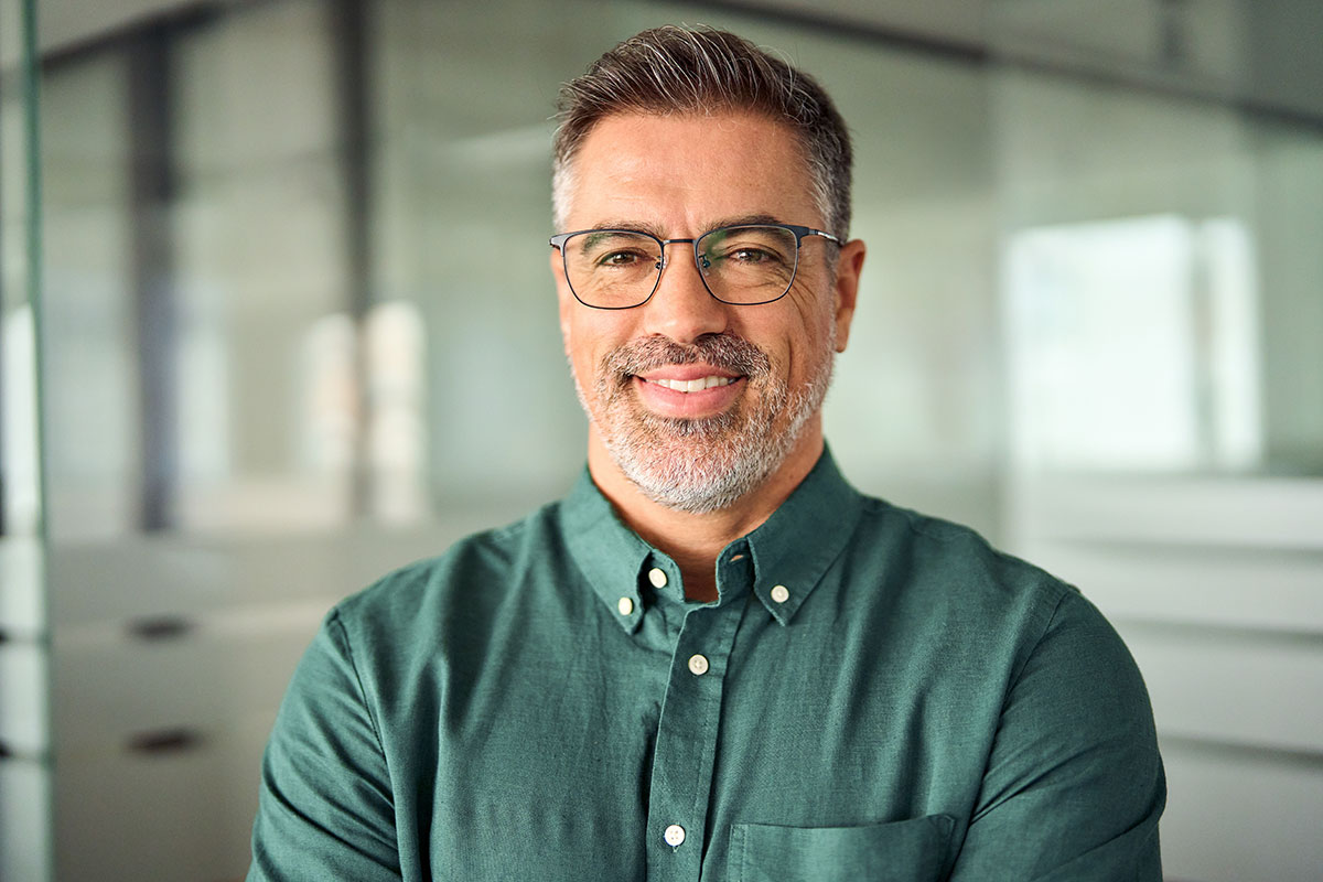 Smiling man in green shirt